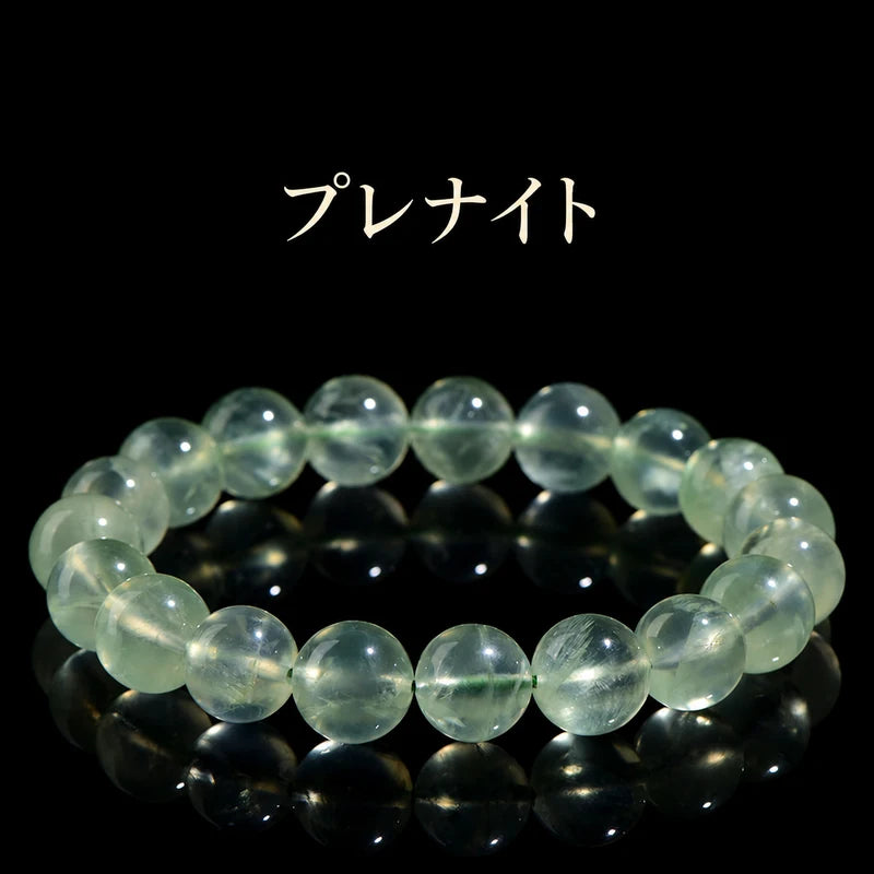 黒い背景に置いた、淡い緑色の透明感が見えるプレナイトの丸玉ブレスレット