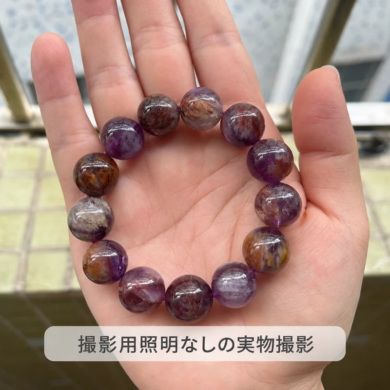 撮影用照明を使わずに撮影した、手のひらに載せたパープルファントムクォーツブレスレット