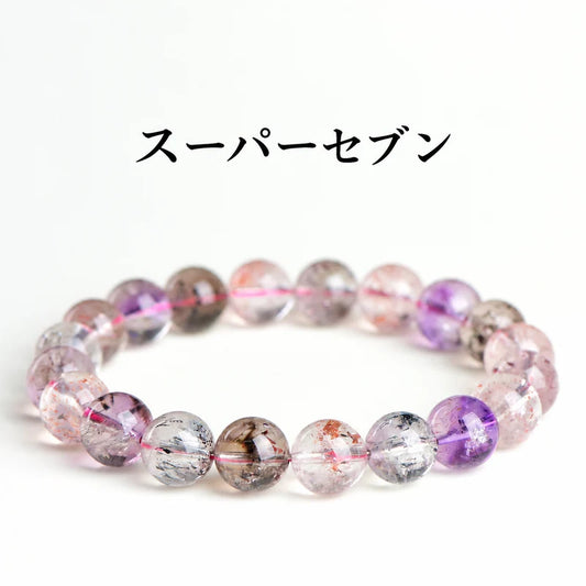 白い背景に置いた、紫や透明の丸玉に多彩な内包物が見えるスーパーセブンブレスレット